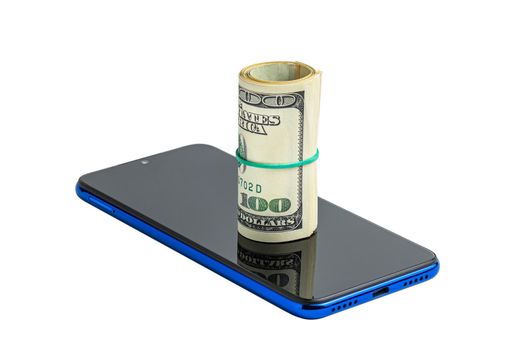 Money in a roll, tied with an elastic band, on the phone. The isolated object on a white background. U.S. dollars. Phone and dollars isolated on white.