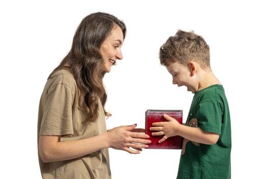 Mother offering present to her son. Boy is very surprised by gift. Isolated on white background.