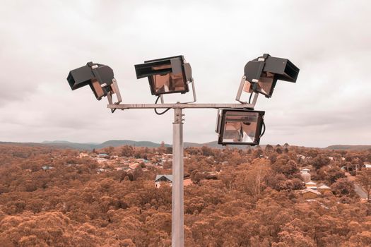 Aerial view of a 4 head sports field lighting structure on a white cloud background