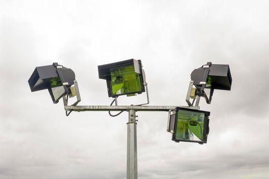 Aerial view of a 4 head sports field lighting structure on a white cloud background