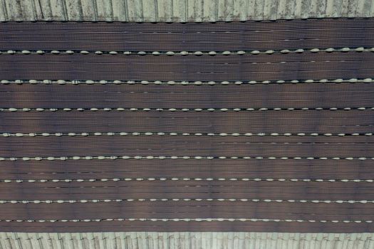 Hot water pipes on a green tiled roof in the bright sunshine.