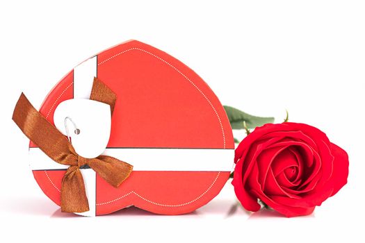 Close up red rose and heart-shaped box on white background, Wedding concept with roses and red heart-shaped box