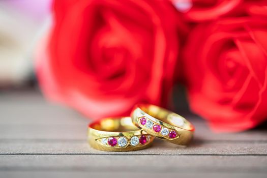 Close up wedding ring and red rose . Love concept