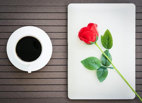 Top view coffee time valentine's day concept ,Desk table with laptop,notebook, coffee cup,red rose