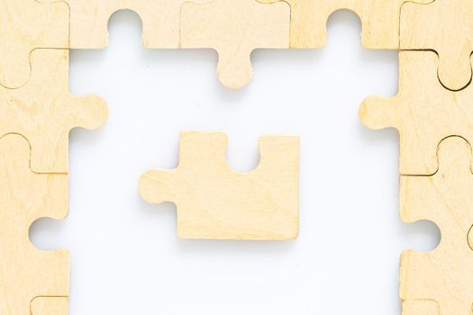 Shot of wooden jigsaw puzzle pieces on white background,Business concept