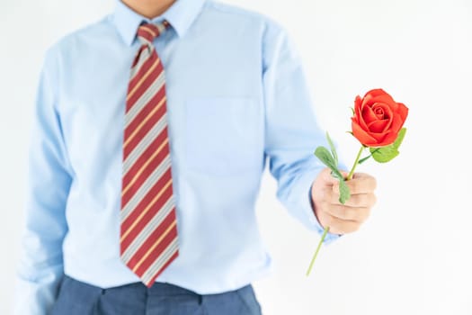 Close up photo of man holding with red rose on white background