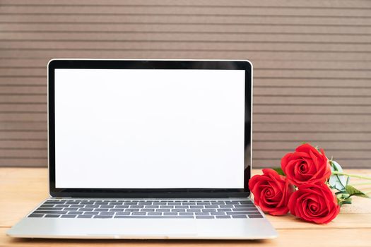 Red rose and laptop mockup on wood background, Valentine concept