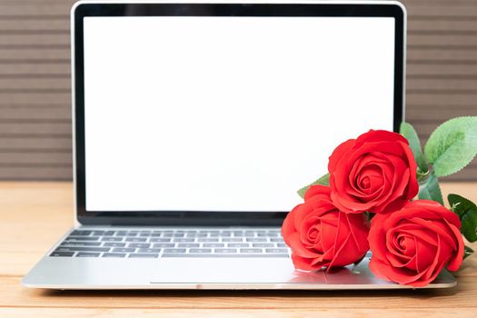 Red rose and laptop mockup on wood background, Valentine concept