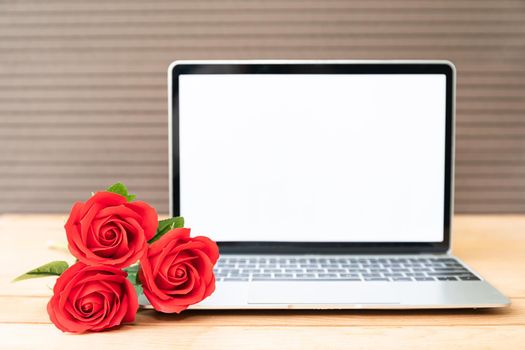 Red rose and laptop mockup on wood background, Valentine concept