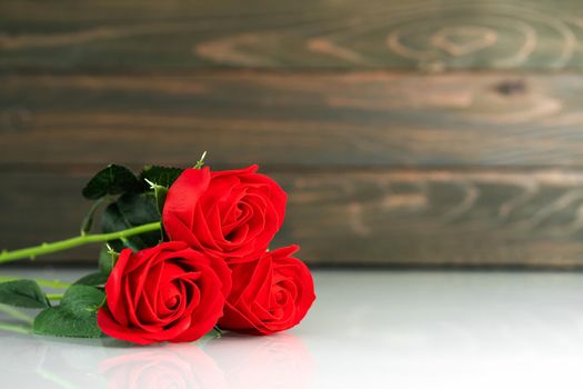 Red roses on table with copy space, Valentine's day background with red roses