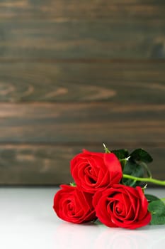 Red roses on table with copy space, Valentine's day background with red roses