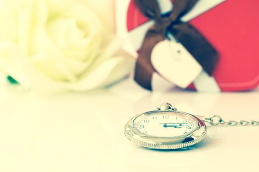 White rose and heart-shaped box on white background, Valentine'sDay concept