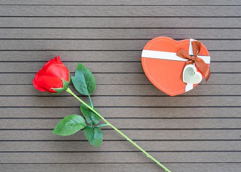 Top view  Valentine's Day concept with red roses and red heart-shaped box