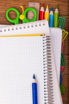 Office supply and notepad on wooden table