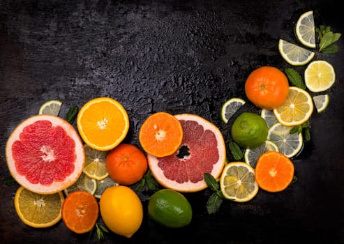 Citrus background. Fresh citrus fruits - Lemons, oranges, limes, grapefruits On wooden background