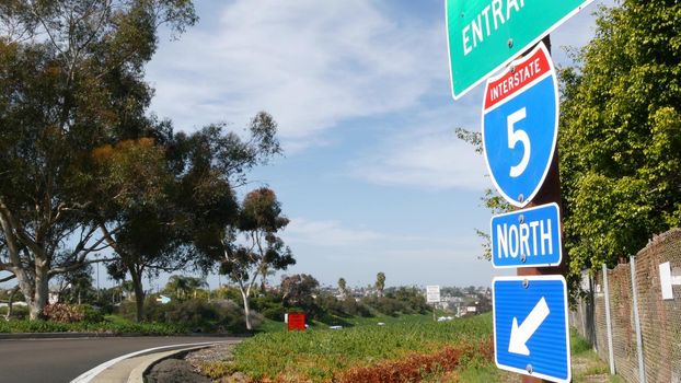 Freeway entrance, information sign on crossraod in USA. Route to Los Angeles, California. Interstate highway 5 signpost as symbol of road trip, transportation and traffic safety rules and regulations.