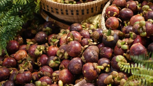 Fruits and vegetables on rustic stall. Assorted fresh ripe fruits and vegetables placed on rustic oriental stall in market. sweet tropical purple mangosteen. Queen of fruits in Thailand.
