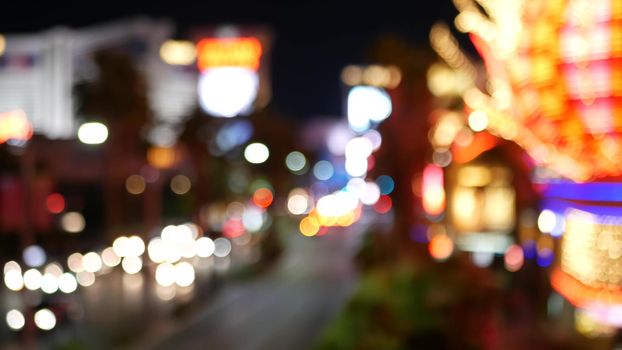 Defocused fabulous Las Vegas Strip boulevard, luxury casino and hotel, gambling area in Nevada, USA. Nightlife and traffic near Fremont street in tourist money playing resort. Neon lights of sin city.