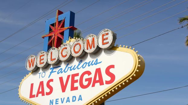 Welcome to fabulous Las Vegas retro neon sign in gambling tourist resort, USA. Iconic vintage banner as symbol of casino, games of chance, money playing and hazard betting. Lettering on signboard.