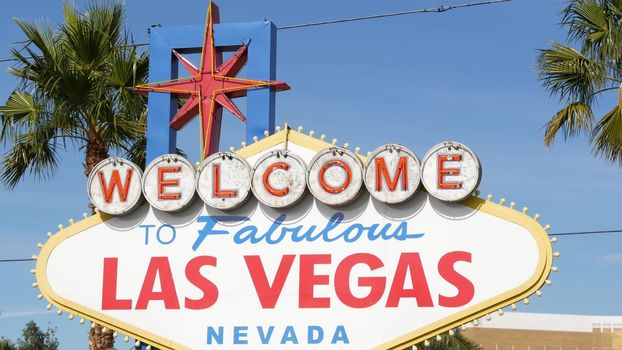 Welcome to fabulous Las Vegas retro neon sign in gambling tourist resort, USA. Iconic vintage banner as symbol of casino, games of chance, money playing and hazard betting. Lettering on signboard.