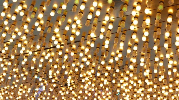 Old fasioned electric lamps blinking and glowing at night. Abstract close up of retro casino decoration shimmering in Las Vegas, USA. Illuminated vintage style bulbs glittering on Freemont street.