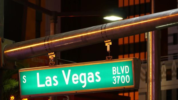 Fabulos Las Vegas, traffic sign glowing on The Strip in sin city of USA. Iconic signboard on the road to Fremont street in Nevada. Illuminated symbol of casino money playing and bets in gaming area.