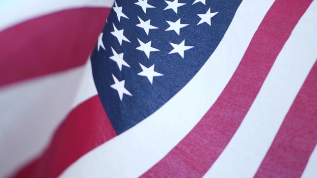 Soft focus close up of American Old Glory flag waving on wind. Stars and Stripes democracy, patriotism, freedom and Independence Day symbol. Star-spangled Banner, national pride and icon of liberty.