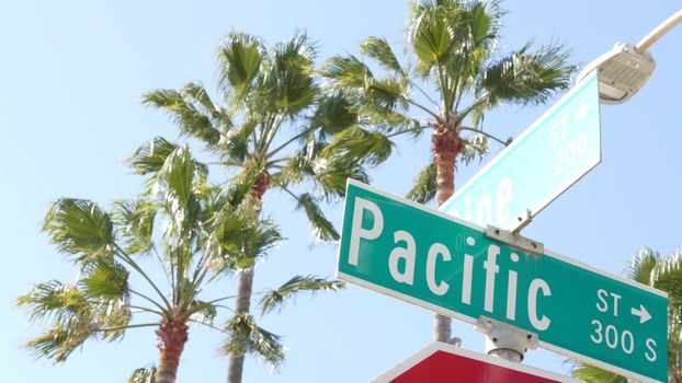 Pacific street road sign on crossroad, route 101 tourist destination, California, USA. Lettering on intersection signpost, symbol of summertime travel and vacations.Signboard in city near Los Angeles.