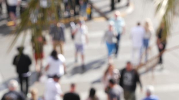 Defocused crowd of people, road intersection crosswalk on The Strip of Las Vegas, USA. Anonymous blurred pedestrians on walkway in crowded urban downtown. Unrecognizable american citizens in sin city.