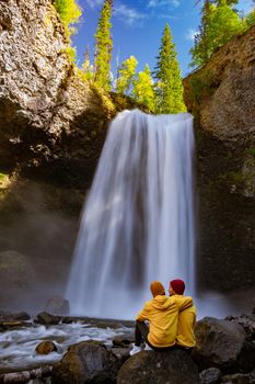 Wells Gray British Colombia Canada, couple on vacation visit spectacular water flow hikingof Helmcken Falls on the Murtle River in Wells Gray Provincial Park Clearwater, British Columbia, 