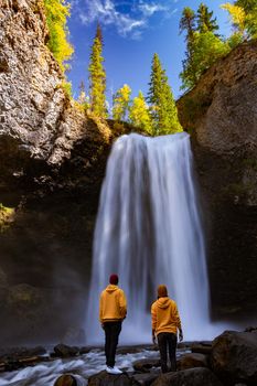 Wells Gray British Colombia Canada, couple on vacation visit spectacular water flow hikingof Helmcken Falls on the Murtle River in Wells Gray Provincial Park Clearwater, British Columbia, 