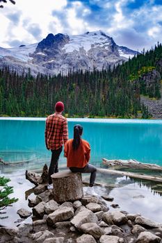 Majestic mountain lake in Canada. Upper Joffre Lake Trail View, couple visit Joffre Lakes Provincial Park - Middle Lake. British Colmbia Canada