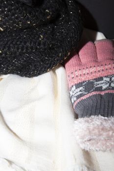 White and gold scarf, black and gold winter hat, and pink and grey winter gloves