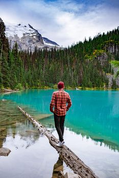 Majestic mountain lake in Canada. Upper Joffre Lake Trail View, men visit Joffre Lakes Provincial Park - Middle Lake. British Columbia Canada, man hiking by the lake