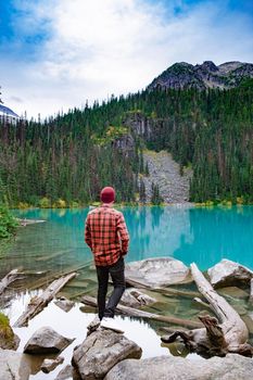 Majestic mountain lake in Canada. Upper Joffre Lake Trail View, men visit Joffre Lakes Provincial Park - Middle Lake. British Columbia Canada, man hiking by the lake