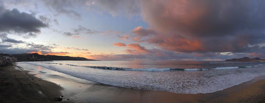 Panorama from dark clouds above Las Canteras beach during sunset in Las Palmas, Gran Canaria