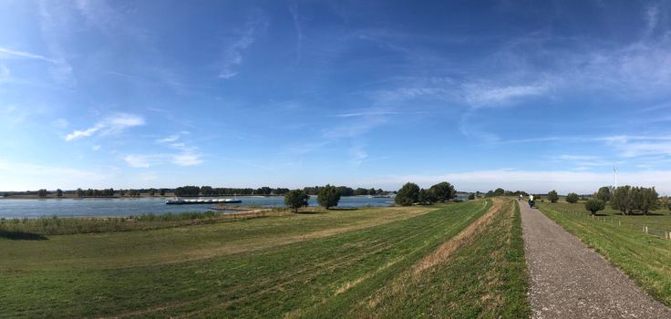 Bicycle path and the Rhine river around Vissel in Germany