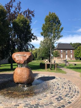 Village fountain at Quirinusplatz in Millingen, Germany