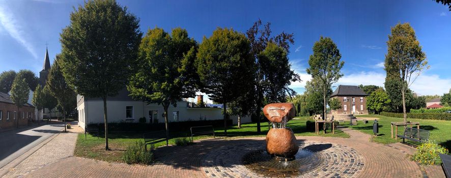 Panorama from village fountain at Quirinusplatz in Millingen, Germany