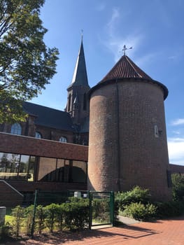 Historic city tower and the St. Bartholomäus church in Isselburg, Germany