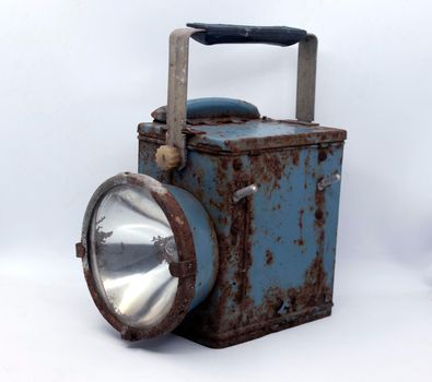 Old rusty blue railway lantern on white background.