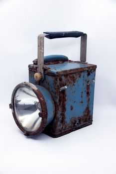 Old rusty blue railway lantern on white background.