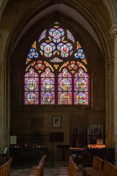 Rouen Cathedral Normandy France 9.25.2019 one of the greatest examples of the high gothic church from 13th cent. Beautiful stained glass window with votive candles. Extensive exterior decoration of the finest quality and the high vaulted ceilings inside with organic ribbing. 