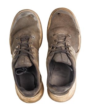 a pair of weared dirty sneakers isolated on white background,, flat lay perspective vew from above