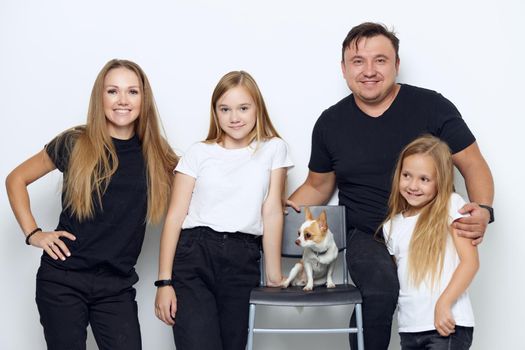 funny family portrait with a small dog. High quality photo