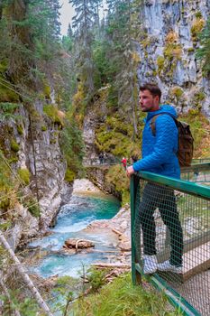 Beautiful Johnston Canyon walkway with turquoise water below, in Banff National Park, Alberta, Canada, lovely blue river