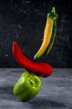 Colorful fresh peppers on gray background template.