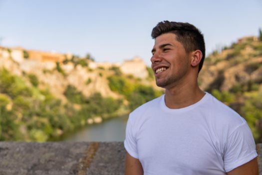 Man with white shirt, smiling with rural background