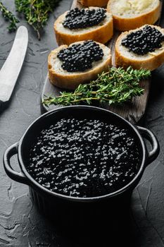 Sandwiche with black caviar, on black background
