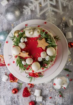 Christmas or New Year decorated cake with cream cheese frosting and cranberries